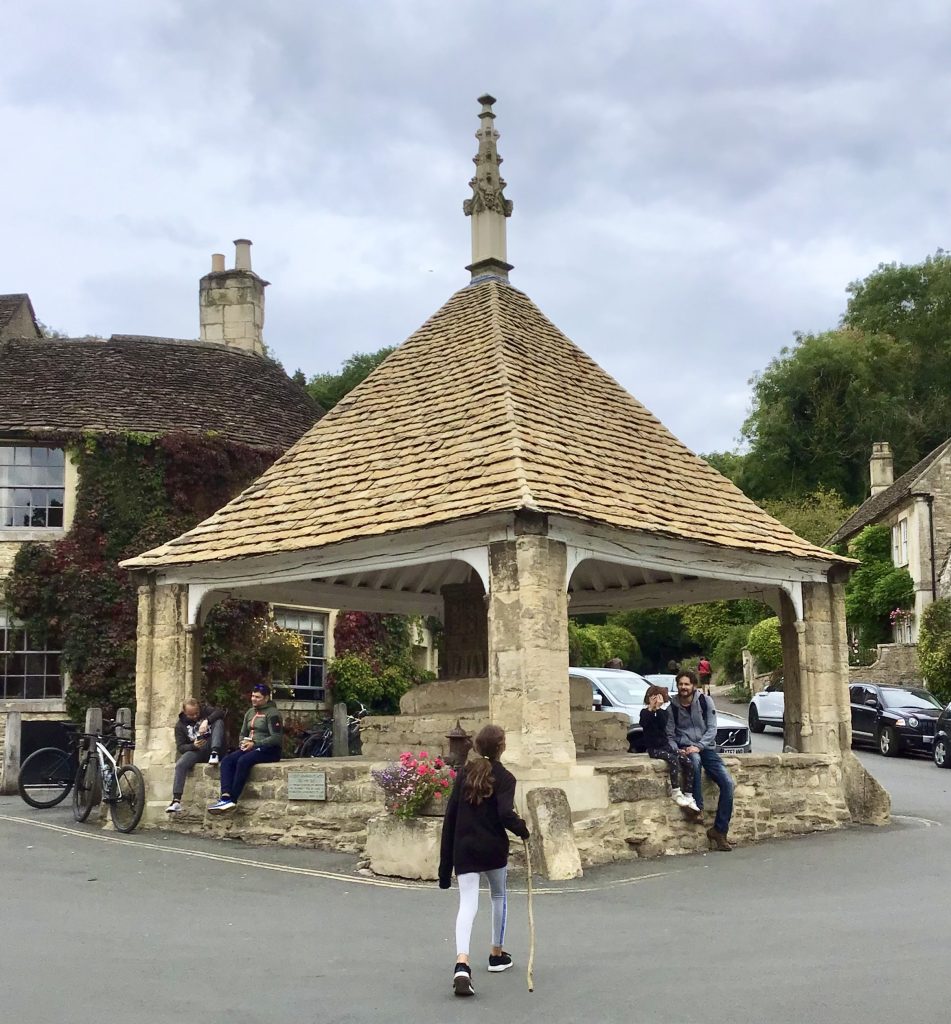 People at the Market Cross in Castle Combe